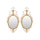 PAIR GILT FRAMED PER MIRRORS each with an oval plate within a moulded gadrooned frame, below an