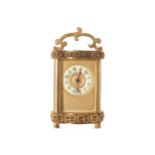 NINETEENTH-CENTURY FRENCH GILT BRONZE FRAMED CARRIAGE CLOCK of rectangular serpentine form 11 cm.