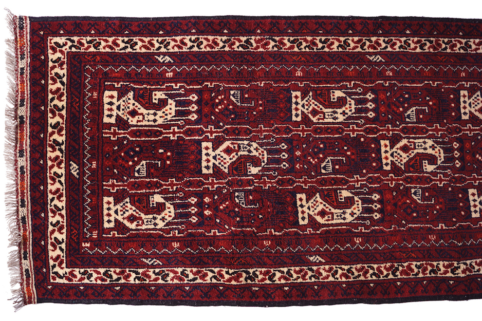 WOOL AND GOAT HAIR BALUTCH RUNNER on red ground, with Boteh design, ivory border, and outer red