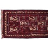 WOOL AND GOAT HAIR BALUTCH RUNNER on red ground, with Boteh design, ivory border, and outer red
