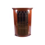 GEORGE III PERIOD MAHOGANY HANGING BOW FRONT CORNER CABINET the moulded crown above a square and