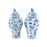 PAIR OF LARGE ORIENTAL BLUE AND WHITE VASES WITH COVERS each surmounted by a fo dog 53 cm. high;