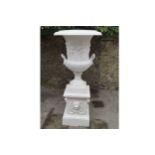 PAIR OF LARGE CAST IRON URNS AND STANDS with lion mask decoration 160 cm. high; 70 cm. diameter (2)