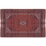 LARGE MID TWENTIETH-CENTURY WEST PERSIAN KASHAN CARPET on red ground, with ivory and blue