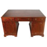 GEORGE III PERIOD MAHOGANY PARTNERâ€™S DESK the tooled leather inset top above a series of three