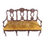 NINETEENTH-CENTURY FRENCH PROVINCIAL SETTEE The triple panelled back above scroll fronted arms and