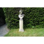 LARGE MOULDED STONE BUST OF APOLLO raised on a fluted column