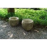 PAIR OF RECONSTITUTED STONE URNS each of circular bulbous form 30 cm. high; 32 cm. diameter (2)