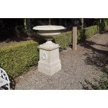 PAIR OF LARGE GEORGIAN CAST IRON URNS each of baluster ribbed form, raised on a stepped laurate