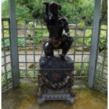 LARGE BRONZE SCULPTURE OF A NUBIAN FIGURE Two children standing on a fence 180 cm. high; 218 cm.