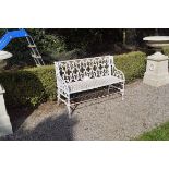 REGENCY PERIOD GOTHIC CAST IRON GARDEN SEAT with tracery panelled back and lozenge seat, raised on