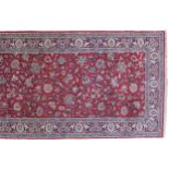 NORTH WEST PERSIAN SILK RUNNERon red ground with all over field and blue border477 x 77 cm.