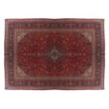 WEST PERSIAN KASHAN CARPETon red ground with blue border414 x 297 cm.