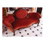 EARLY VICTORIAN WALNUT AND UPHOLSTERED SETTEE the oval deep buttoned upholstered panelled back,