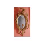 NINETEENTH-CENTURY GILT FRAMED GIRANDOLE the oval bevelled plate within a moulded and vine decorated