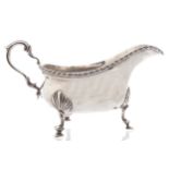 HEAVY SILVER SAUCE BOATBirmingham 1917, with a gadrooned rim, double scroll handle, raised on