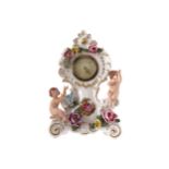 DRESDEN PORCELAIN CASED MANTLE CLOCK encrusted with flowers and mounted with puttiProvenance: The