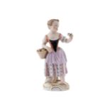 NINETEENTH-CENTURY MEISSEN FIGURE of a young girl holding a basket of fruit14 cm. high