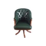 HIDE UPHOLSTERED DEEP BUTTONED EXECUTIVE SWIVEL ARMCHAIRraised on a scroll pod 83 cm. high; 56 cm.