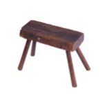 ANTIQUE ELM MILKING STOOL29 cm. high; 38 cm. wide; 21 cm. deep