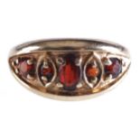 9 CT. GOLD FIVE STONE GARNET GYPSY STYLE RING