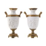PAIR OF NINETEENTH-CENTURY ORMOLU MOUNTED BISQUE VASESeach of baluster form with scroll handles with