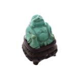 CARVED CHINESE TURQUOISE BUDDHA on a hard wood stand4 cm. high