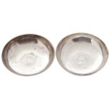 PAIR OF SILVER MIDDLE EASTERN BON BON DISHESeach inserted with a silver coin2 cm. high; 8.5 cm.