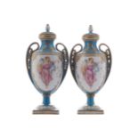 PAIR OF NINETEENTH-CENTURY SEVRES PARCEL GILT URNS AND COVERSeach with nymph decorated oval panels38