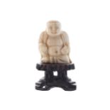 NINETEENTH-CENTURY CHINESE SINO-TIBETAN IVORY BUDDHA on a hard wood base7 cm. high