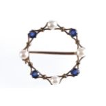 9 CT. GOLD CIRCULAR BROOCH set with Ceylon sapphires and pearls