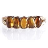 9 CT. GOLD FIVE STONE CABOCHON CUT AMBER RING