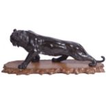 NINETEENTH-CENTURY MEIJI PERIOD BRONZE SCULPTUREof a tiger mounted on a wooden base28 cm. high; 77