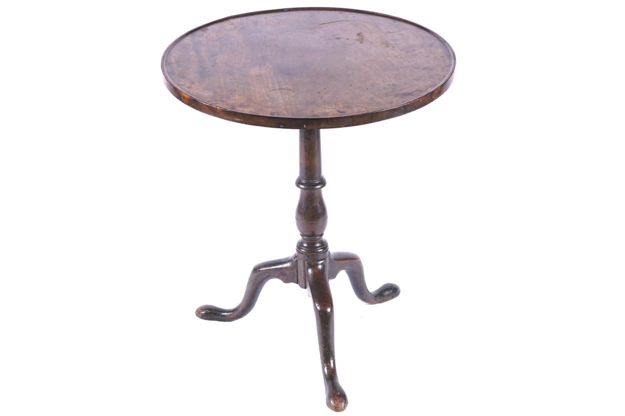 GEORGE III MAHOGANY WINE TABLE the circular dished top, raised on a turned stem and scroll legged