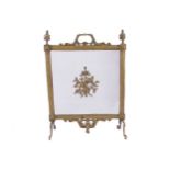 NINETEENTH-CENTURY ARMORIAL BRASS FIRE SCREEN raised on scroll ends 80 cm. high; 60 cm. wide