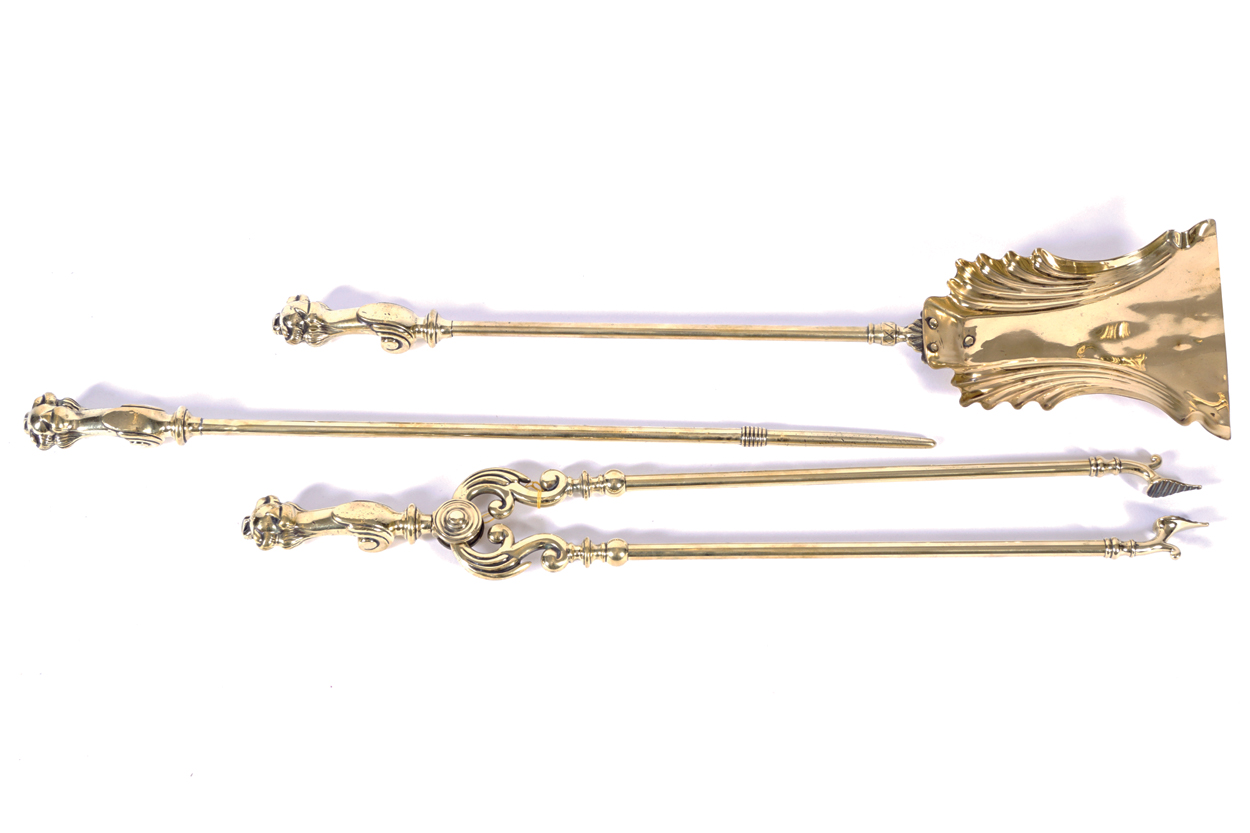 SET OF HEAVY NINETEENTH-CENTURY BRASS FIRE IRONS each with a ball and claw handle 73 cm. long and