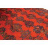 TURKISH PALACE CARPET red ground with central field depicting abstract footprints within a series of