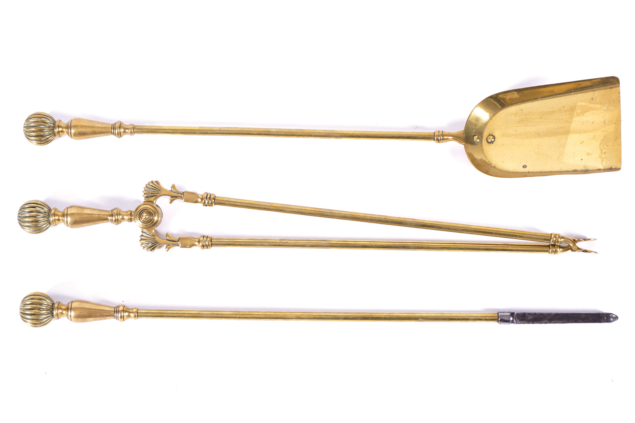 SET OF THREE HEAVY GEORGIAN BRASS FIRE IRONS each with a pommel ribbed handle 69 cm. high (3)