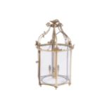 PAIR OF EDWARDIAN BRASS HALL LANTERNS each of octagonal form with glazed panels, suspended on scroll