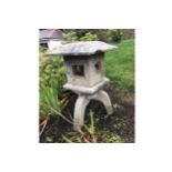 JAPANESE GARDEN STONE SCULPTURE in the form of a lantern raised on scroll supports Provenance: The