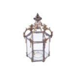GOTHIC REGENCY PERIOD BRASS HALL LANTERN of hexagonal form, with glazed panelled sides, suspended on