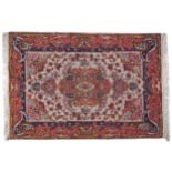 PERSIAN RUG central cream ground panel with polychrome florets and geometric patterns enclosed