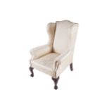 IRISH_NINETEENTH-CENTURY_MAHOGANY AND UPHOLSTERED WING BACK ARM CHAIR raised on acanthus leaf carved