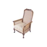 PAIR OF EDWARDIAN MAHOGANY FRAMED BERGERE PANELLED ARMCHAIRS a rocking chair and an elbow chair