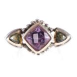 14 CT. WHITE GOLD THREE STONE RING set with an amethyst and two cabochon cut peridot stones