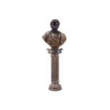 BLACK MARBLE BUST OF CAESER with mottled tunic, raised on a reeded stemmed turned column 165 cm.