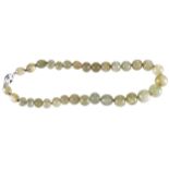 CELADON GREEN JADE NECKLACE of round beads with silver clasp Provenance: The Maureen O'Hara