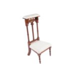PRIE-DIEU CHAIR the cushioned arm rest above a gothic double arched pierced back above an