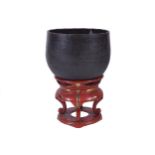 LATE EIGHTEENTH/EARLY NINETEENTH-CENTURY BUDDHIST COPPER SINGING BOWL on a Japanese circular red