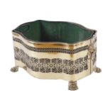 LARGE EDWARDIAN BRASS LOG BOX of oval serpentine form, furnished with a metal liner, the pierced